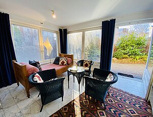 Ferienwohnung der Villa Caprivi E1 mit Terrasse im Grünen und Wintergarten als Wohnbereich
