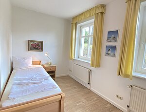 Einzelbett im gemeinsamen Schlafzimmer ohne Trennwand